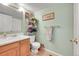 Clean and functional bathroom with wood vanity and linen storage at 8404 S Everett Way # B, Littleton, CO 80128