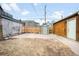 Wide backyard view, featuring a wooden shed, a storage shed, and a wooden fence at 2311 N Gilpin St, Denver, CO 80205