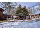 Landscaped courtyard with trees, arbor, and snow at 10125 W 25Th Ave # 47, Lakewood, CO 80215