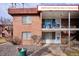 Charming brick two-story condo with a cozy balcony and a well-maintained landscape at 10125 W 25Th Ave # 47, Lakewood, CO 80215