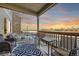 Cozy covered patio with wicker furniture, string lights, and sunset view at 1867 Homestead Dr, Fort Lupton, CO 80621