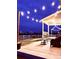 Evening view of a backyard patio with string lights and seating at 1867 Homestead Dr, Fort Lupton, CO 80621