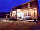 Enjoy outdoor living with a covered patio and string lights, perfect for evening relaxation at 1867 Homestead Dr, Fort Lupton, CO 80621