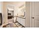 Bright bathroom with double sinks, modern lighting, and a glimpse into a connected bedroom, creating a functional space at 1867 Homestead Dr, Fort Lupton, CO 80621