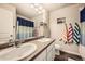 Bright bathroom features a double sink vanity, large mirror, and colorful accessories at 1867 Homestead Dr, Fort Lupton, CO 80621