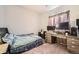 Bedroom with a gray bedspread, a desk, and two monitors at 1867 Homestead Dr, Fort Lupton, CO 80621