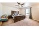 Cozy bedroom features a king-sized bed, a ceiling fan, and a large window, creating a relaxing and inviting space at 1867 Homestead Dr, Fort Lupton, CO 80621