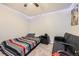 This cozy bedroom features neutral walls, and a futon for extra seating at 1867 Homestead Dr, Fort Lupton, CO 80621