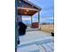 This covered patio features string lights, an outdoor kitchen, and space for entertaining at 1867 Homestead Dr, Fort Lupton, CO 80621