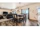 Bright dining area with table and chairs, adjacent to living room at 1867 Homestead Dr, Fort Lupton, CO 80621