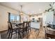 Bright dining area with a table and six chairs, adjacent to kitchen at 1867 Homestead Dr, Fort Lupton, CO 80621