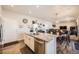 Modern kitchen with white cabinets, granite island, and stainless steel appliances at 1867 Homestead Dr, Fort Lupton, CO 80621