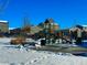 Community playground with a bench, covered in a light layer of snow at 1867 Homestead Dr, Fort Lupton, CO 80621