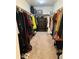 Spacious walk-in closet with ample hanging space, built-in shelving, and carpeted flooring, providing optimal organization at 1867 Homestead Dr, Fort Lupton, CO 80621