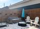 Backyard patio with furniture, wood fence, and fire pit, perfect for outdoor enjoyment at 4571 Stuart St, Denver, CO 80212