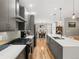 Modern kitchen with gray cabinets, quartz countertops, stainless steel appliances, and a large island at 4571 Stuart St, Denver, CO 80212