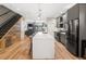 Modern kitchen with a large island, stainless steel appliances, and open layout at 4571 Stuart St, Denver, CO 80212