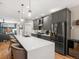 Sleek kitchen with a spacious island, modern gray cabinets, and open floor plan at 4571 Stuart St, Denver, CO 80212
