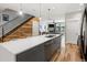 Stylish kitchen showcasing an island with quartz countertop, wood accents, and stainless steel appliances at 4571 Stuart St, Denver, CO 80212