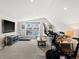 Open-concept living room featuring neutral carpeting, recessed lighting, and window views of the outdoors at 4571 Stuart St, Denver, CO 80212