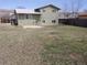 Backyard featuring a large grassy area with a patio and fencing at 8353 Gaylord St, Denver, CO 80229