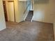 Finished basement with carpeted floors, stairs, and closet at 8353 Gaylord St, Denver, CO 80229