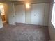 Comfortable bedroom features plush carpeting, neutral walls, and generous closet space, creating a serene retreat at 8353 Gaylord St, Denver, CO 80229