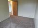 Bedroom featuring neutral walls and carpet, and a wooden door at 8353 Gaylord St, Denver, CO 80229