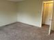 Bright bedroom features plush carpeting, neutral walls, and an open doorway with access to a closet at 8353 Gaylord St, Denver, CO 80229