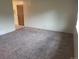 Inviting living room with plush carpeting, neutral walls, and abundant natural light, perfect for relaxation at 8353 Gaylord St, Denver, CO 80229
