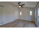 This bedroom features wood floors, three windows, and a ceiling fan at 1767 High Plains Ct, Superior, CO 80027