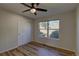 This bedroom features wood floors, a ceiling fan, a window view, and a closet at 1767 High Plains Ct, Superior, CO 80027