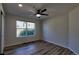 Clean bedroom with hardwood floors, a ceiling fan, and a window with a view of greenery at 1767 High Plains Ct, Superior, CO 80027