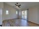 This bedroom has wood floors, three windows, a sliding glass door, and a ceiling fan at 1767 High Plains Ct, Superior, CO 80027