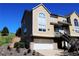 Charming townhouse featuring a stone-accented base, attached garage, and private entrance on a clear day at 1767 High Plains Ct, Superior, CO 80027