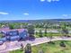A beautiful exterior view of a blue multi-story townhome on a tree-lined street with attached garage at 1767 High Plains Ct, Superior, CO 80027