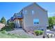Tan home with stone accents, a well-manicured lawn, and lovely deck at 1767 High Plains Ct, Superior, CO 80027
