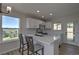 Well-lit kitchen with white cabinetry, a quartz countertop island, and a view of the outdoors at 1767 High Plains Ct, Superior, CO 80027