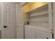 This laundry area has a washer, dryer, shelving, and bi-fold doors at 1767 High Plains Ct, Superior, CO 80027
