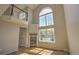 Bright living room featuring a fireplace, hardwood floors, and soaring windows for natural light at 1767 High Plains Ct, Superior, CO 80027