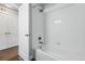 Bathroom features a full bathtub with tiled walls, and modern fixtures at 15628 W Baker Ave, Lakewood, CO 80228