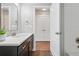 Bathroom with modern vanity, sleek fixtures, and an open view of the shower and closet at 15628 W Baker Ave, Lakewood, CO 80228