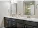 Bathroom boasts double sinks, dark wood cabinets, quartz countertops, and modern fixtures at 15628 W Baker Ave, Lakewood, CO 80228