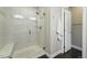 Bathroom boasts glass enclosed shower with bench and tile surround and chrome fixtures at 15628 W Baker Ave, Lakewood, CO 80228