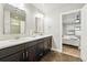 Bathroom boasts double sinks, dark wood cabinets, quartz countertops and entry to bedroom at 15628 W Baker Ave, Lakewood, CO 80228