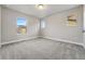 Bright bedroom with three windows and neutral carpet, ready for personalization at 15628 W Baker Ave, Lakewood, CO 80228