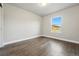 Empty bedroom with wood flooring and large window at 15628 W Baker Ave, Lakewood, CO 80228