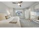 Bright bedroom features plush carpet, ceiling fan, neutral decor and large window at 15628 W Baker Ave, Lakewood, CO 80228