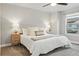 Inviting bedroom with a large window, ceiling fan and neutral decor at 15628 W Baker Ave, Lakewood, CO 80228