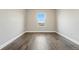 Empty bedroom features wood flooring and large window at 15628 W Baker Ave, Lakewood, CO 80228